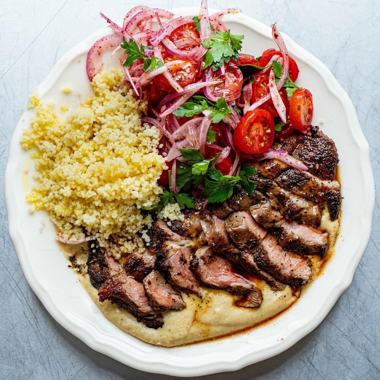 Lamb Leg Steaks with Hot Hummus Couscous Sumac Tomatoes